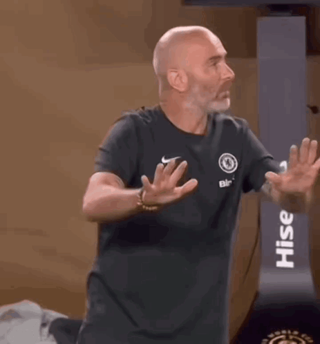 Man In Black Shirt Smiling Arms Outstretched In Front Of Crowd GIF