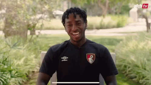 Man in Black Shirt Smiling in Park