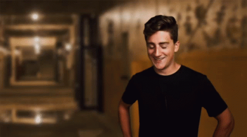 Man In Black Shirt Smiling With Eyes Closed GIF