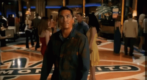 Man In Black Shirt Standing Before Monte Sign GIF