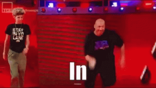Man in Black Shirt Standing in Front of Crowd Saying In