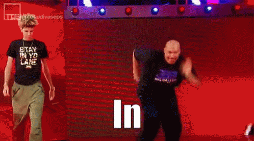 Man in Black Shirt Standing in Front of Crowd Saying In