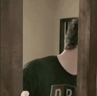 Man in Black Shirt Standing in Front of Door