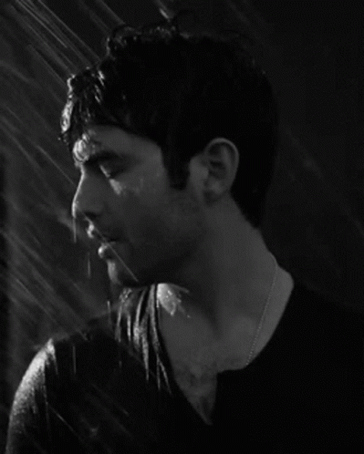 Man in Black Shirt Standing in Rain