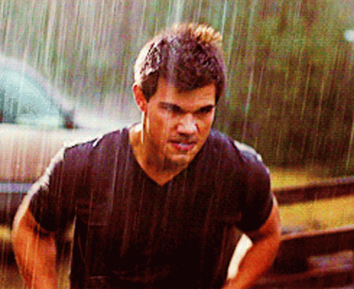 Man In Black Shirt Standing In Rain GIF