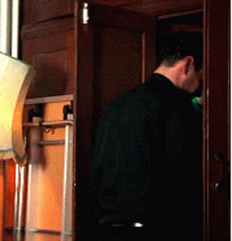 Man In Black Shirt Standing In Room GIF