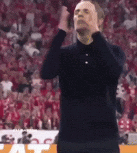 Man in Black Shirt Standing With Hands on Head