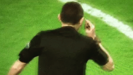 Man in Black Shirt Talking on Cell Phone Soccer Field