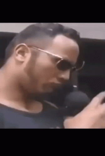 Man In Black Shirt Talking On Phone GIF