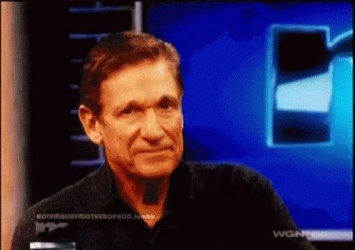 Man in Black Shirt Talking on TV