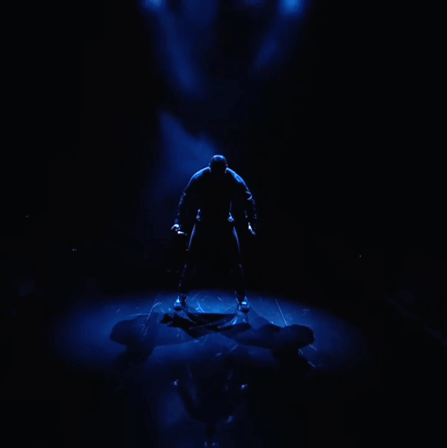 Man in Black Shirt Tie Before Blue Light
