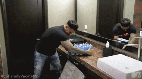 Man in Black Shirt Washing Hands