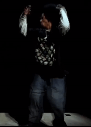 Man in Black Shirt with Chinese Writing Dancing