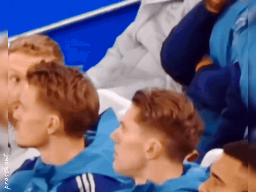 Man In Black Shirt With Crown Dancing In Front Of Manchester Logo GIF