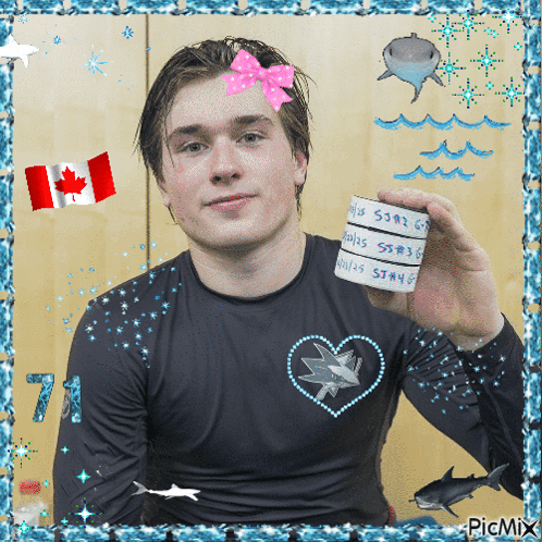 Man in Black Shirt With Hearts and Sharks Holding Paper
