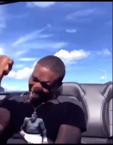 Man In Black Shirt With Man Statue GIF
