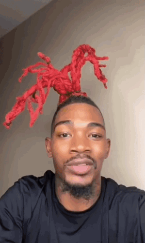 Man In Black Shirt With Red Spider In Hair GIF