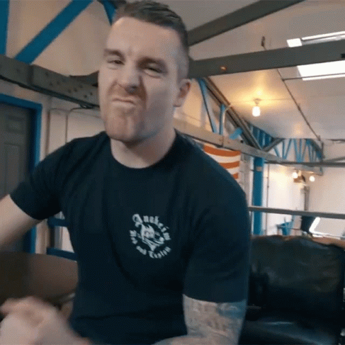 Man In Black Shirt With Skull Making A Face GIF