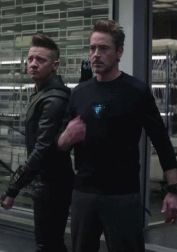 Man In Black Shirt With Triangle Next To Man In Black Jacket GIF