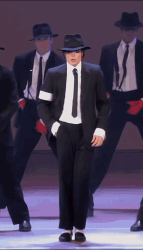 Man In Black Suit And Tie Dancing GIF