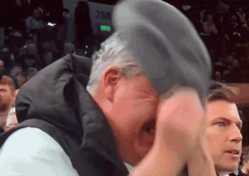 Man in Black Suit Bending Over on Knees