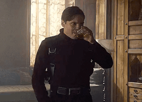 Man in Black Suit Drinking Whiskey