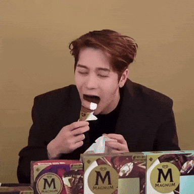 Man in Black Suit Eating Magnum Ice Cream