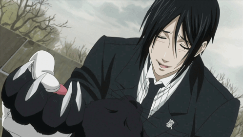 Man in Black Suit Holding Black Cat