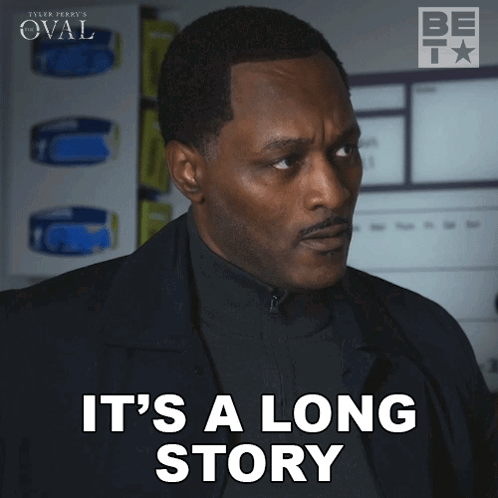 Man In Black Suit Says It's A Long Story GIF