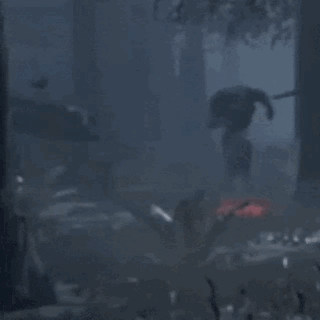 Man In Black Suit Standing In Dark Forest GIF