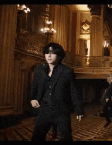 Man In Black Suit Standing On Balcony GIF