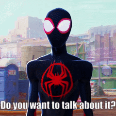 Man in Black Suit with Red Spider Says Do You Want to Talk