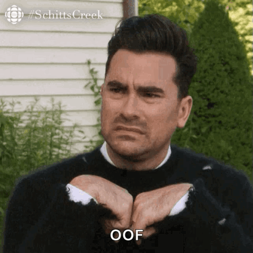 Man in Black Sweater and White Shirt Saying Oof