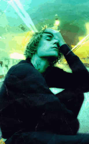 Man in Black Sweater Hand to Face
