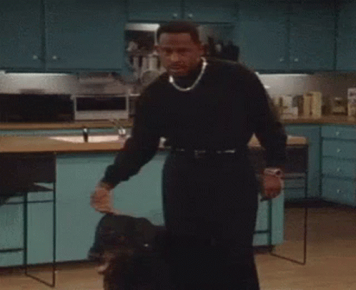 Man in Black Sweater Holding Dog