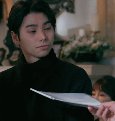 Man In Black Sweater Looking At Paper GIF