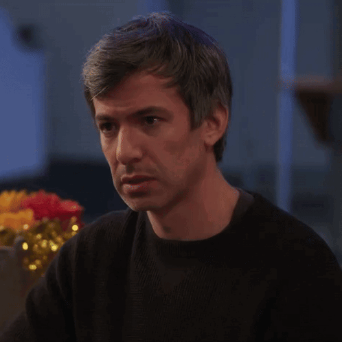 Man in Black Sweater Looking at Something