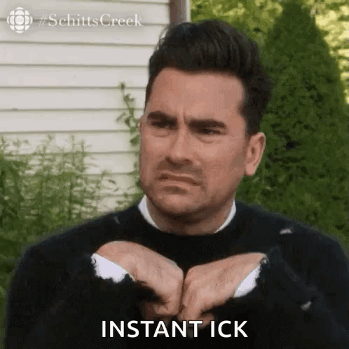Man In Black Sweater Making Funny Face Saying Instant Ick GIF