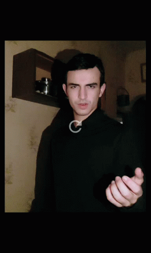 Man In Black Sweater Making Gesture GIF