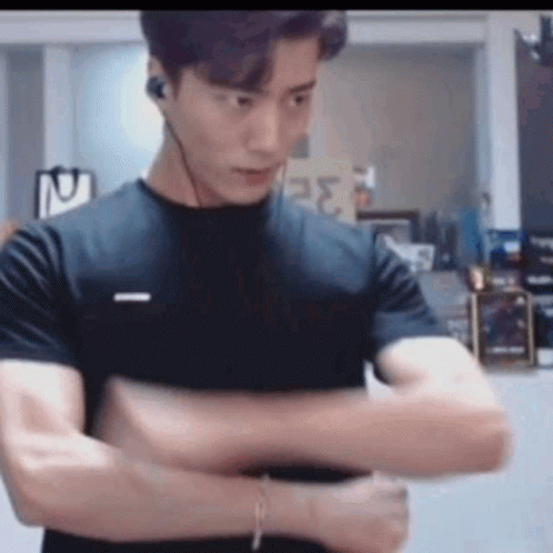 Man In Black T-Shirt And Headphones With Arms Crossed GIF