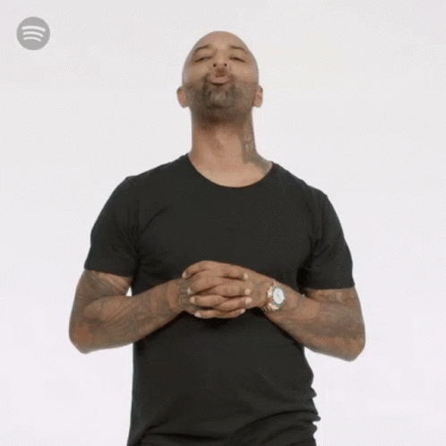 Man in Black T-Shirt and Watch Blowing Kiss