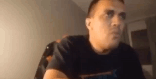 Man In Black T-Shirt Sitting At Table GIF