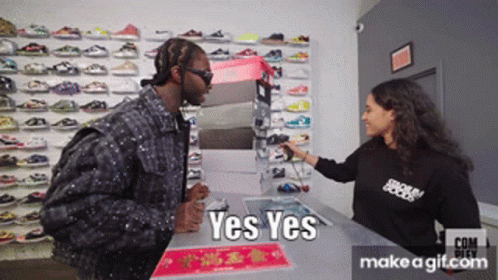 Man in Black Talking to Woman with Yes Yes Shirt