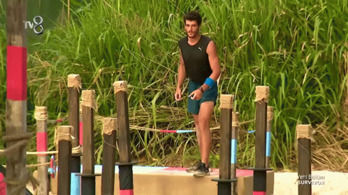 Man in Black Tank Top and Blue Shorts