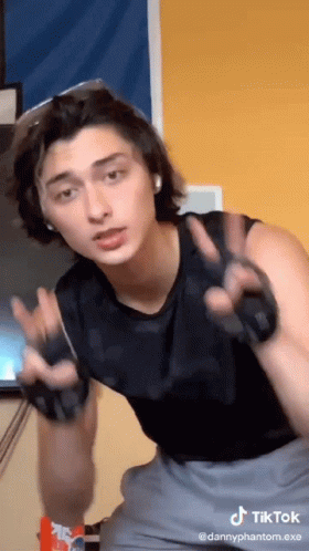 Man in Black Tank Top Giving Peace Sign