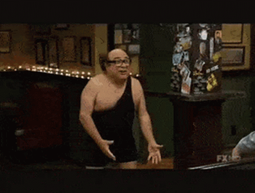 Man In Black Tank Top Next To Man In Gray Hoodie GIF