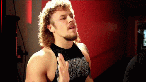 Man in Black Tank Top Saying Texas Wrestling