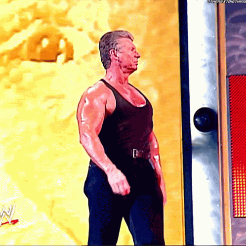Man in Black Tank Top Standing in Front of Door Saying Thenextthing