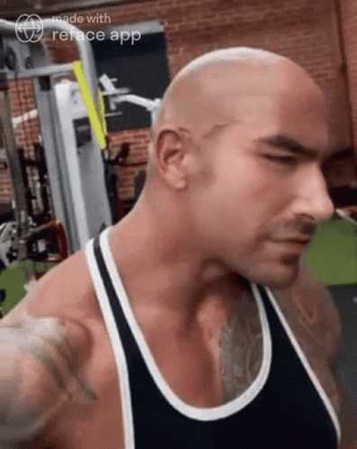 Man In Black Tank Top Standing In Gym GIF