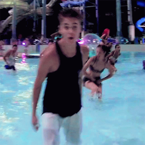 Man In Black Tank Top Standing In Water GIF